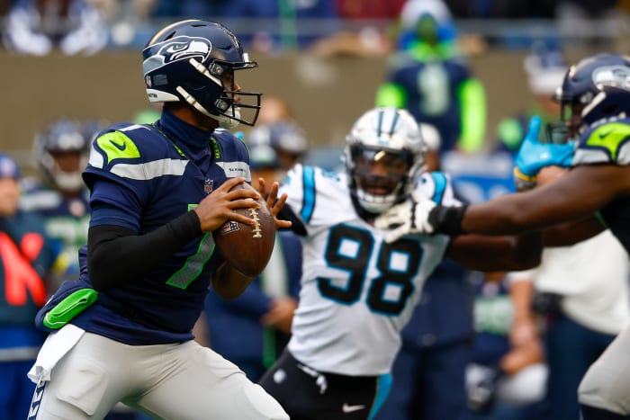 Seattle Seahawks quarterback Geno Smith looks for an open receiver in a game against the Carolina Panthers.